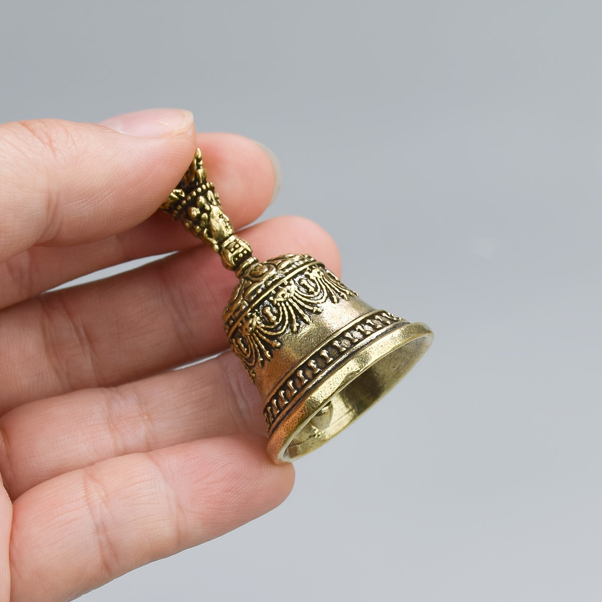 one carved bronze bell hand held shaker clapping handle